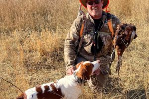 Joyful hunter and his dog